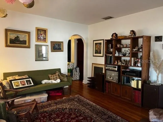 a living room with furniture and wooden floor
