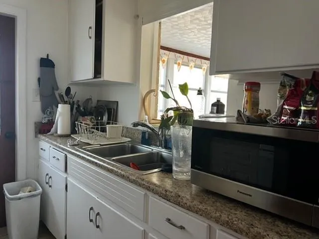 a view of hall way with furniture and wooden floor