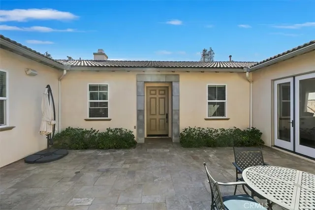 a kitchen with stainless steel appliances granite countertop a sink a stove a refrigerator cabinets and chairs