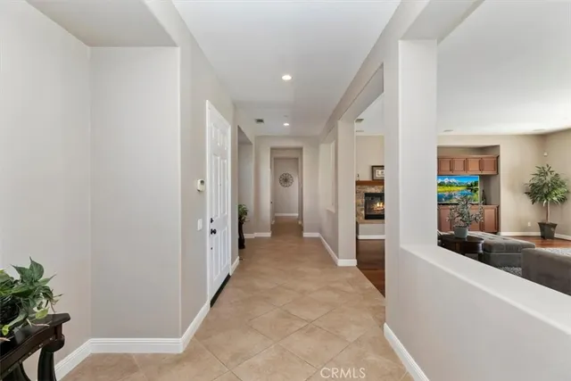 a kitchen with a dining table chairs stainless steel appliances and cabinets