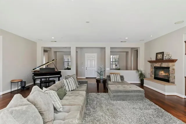 a dining room with furniture a chandelier and wooden floor
