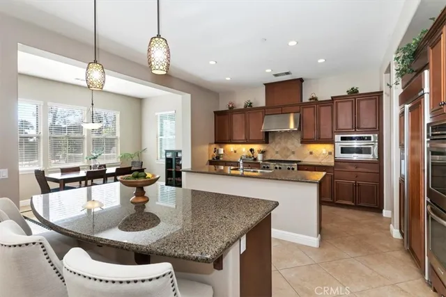 a bathroom with a granite countertop sink a mirror and shower