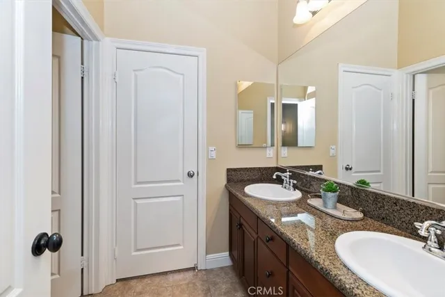 a view of a yard with plants and palm trees
