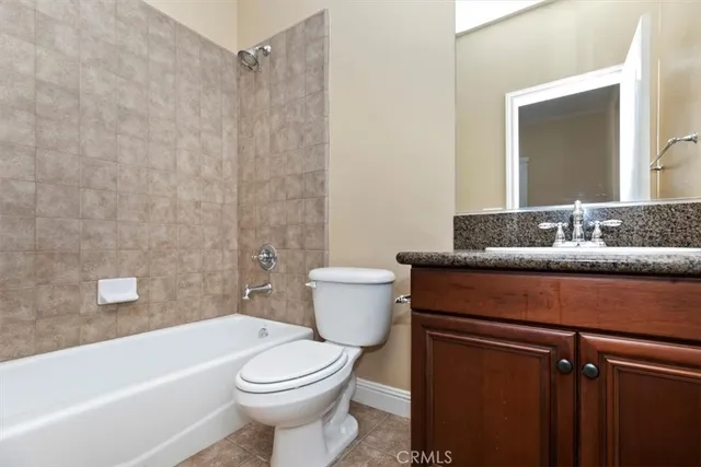 a view of a white house with a big yard and large trees