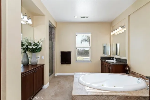 a patio with table and chairs and potted plants