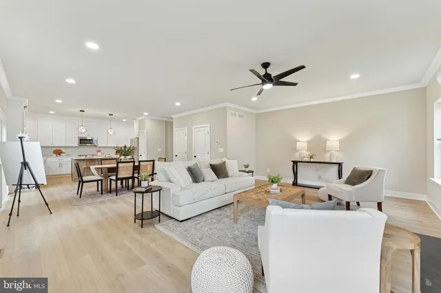 a living room with furniture and kitchen view