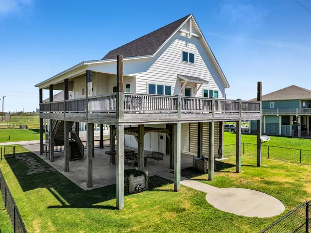a view of a house with a backyard porch and sitting area
