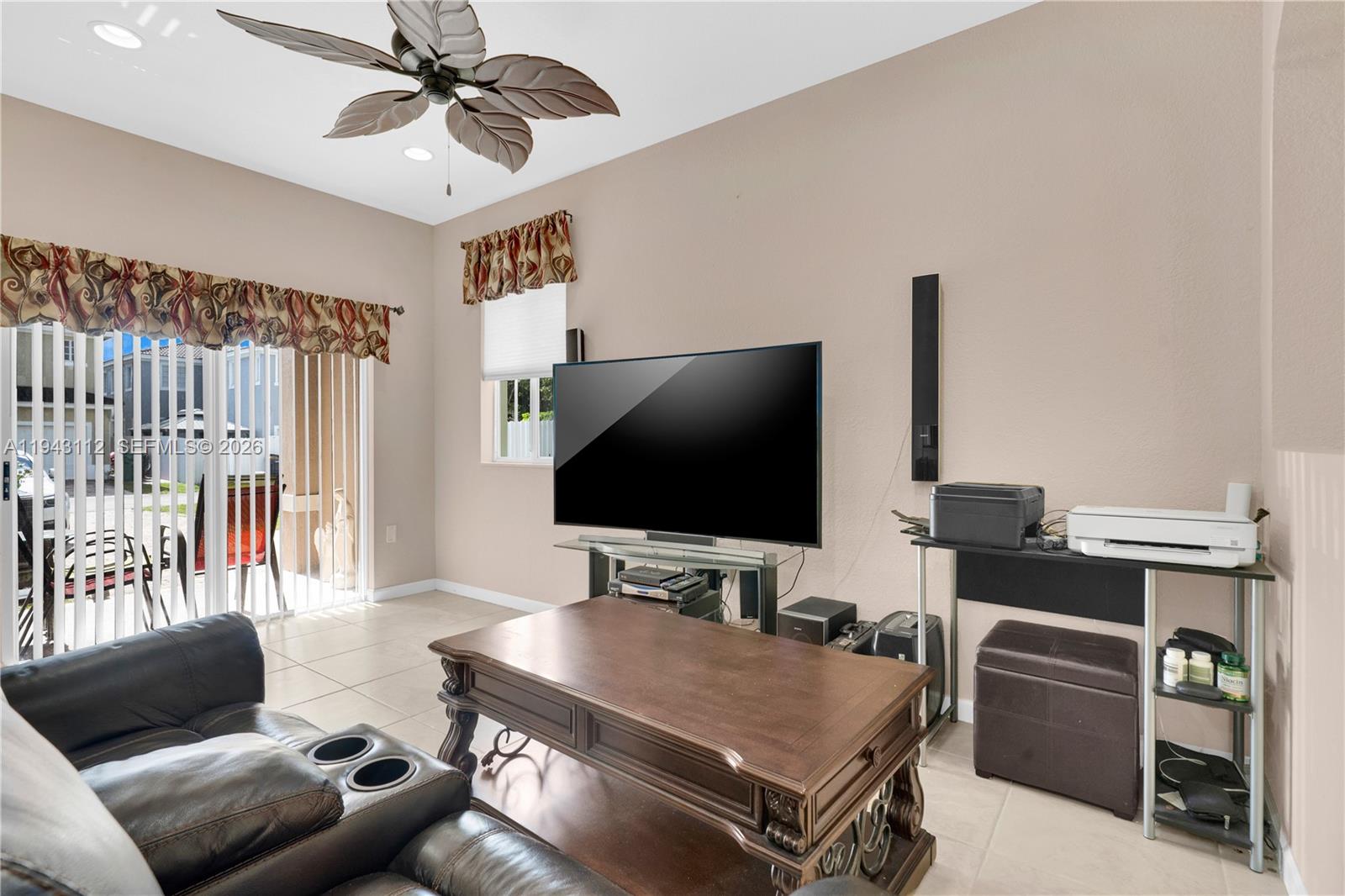 14102 Southwest 276th Street Homestead, FL 33032 - Photo 11 of 36 a living room with furniture and a flat screen tv