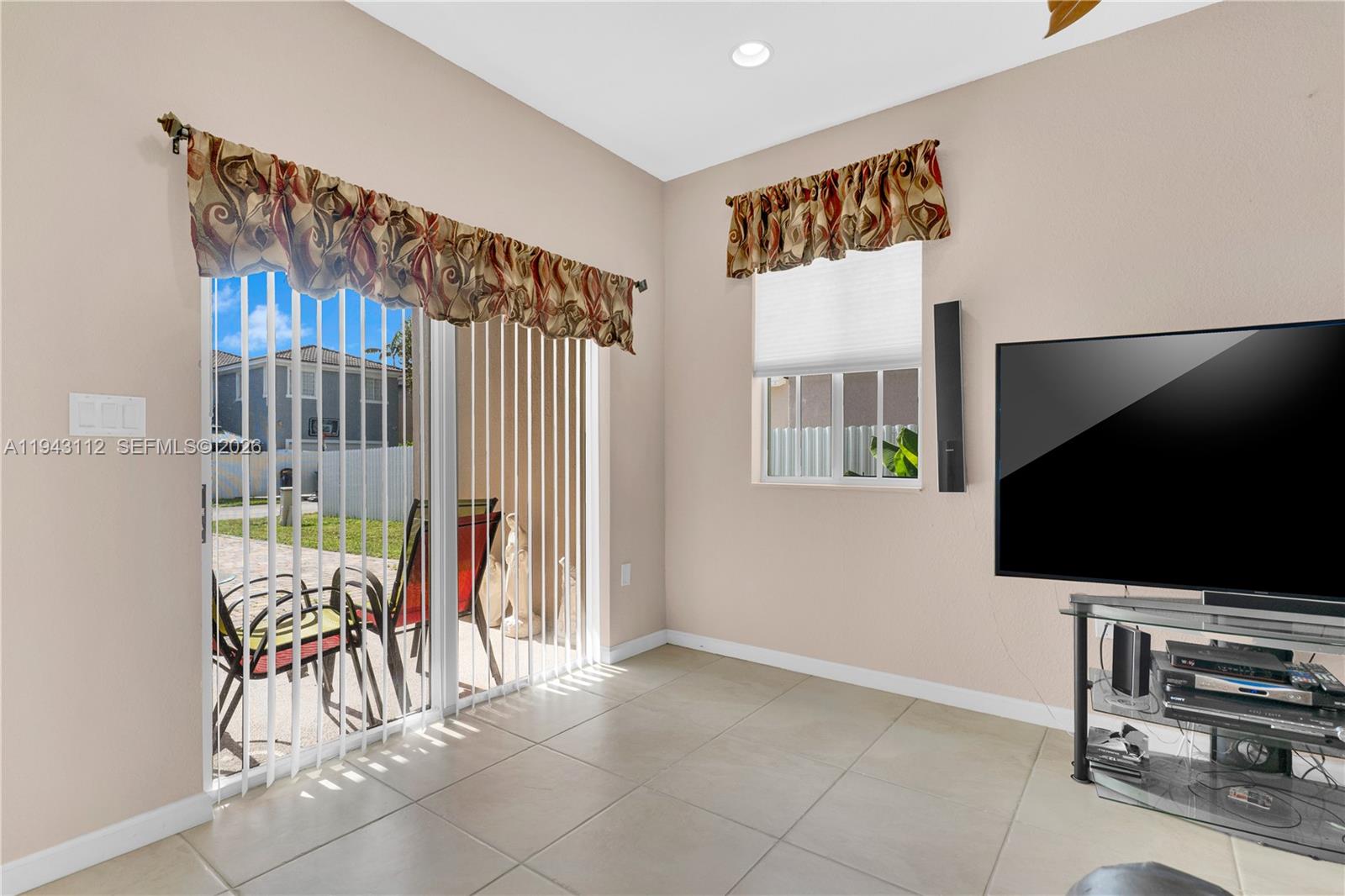 14102 Southwest 276th Street Homestead, FL 33032 - Photo 13 of 36 a view of a livingroom with furniture and a flat screen tv