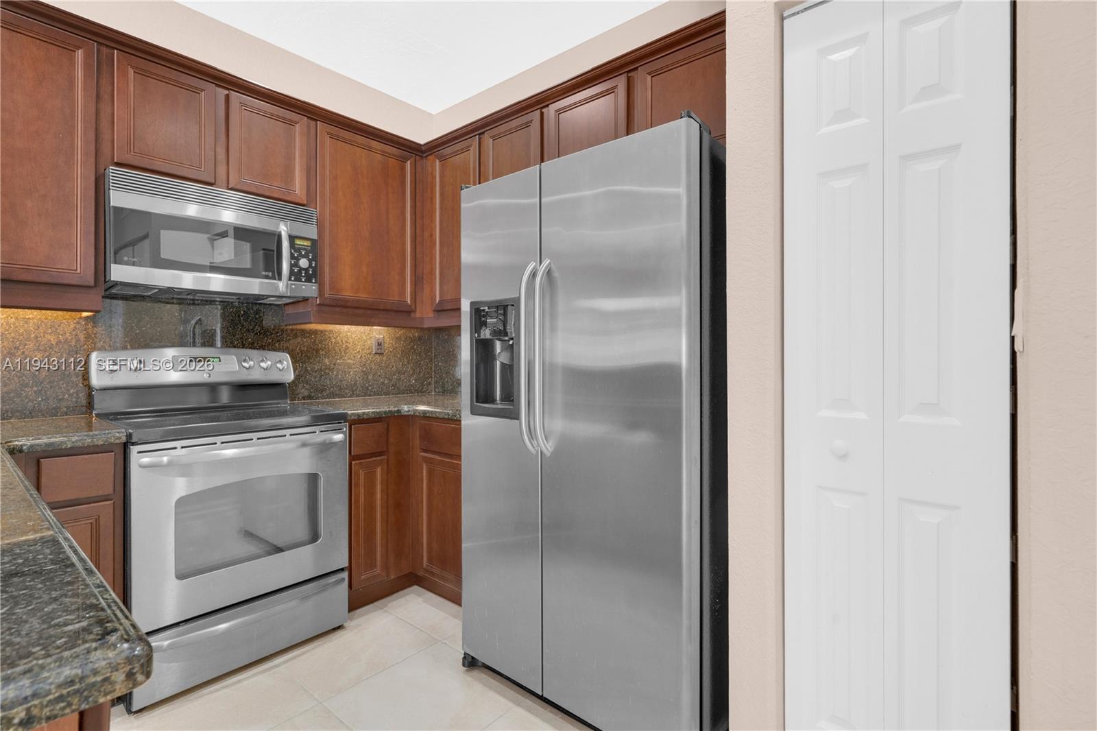 14102 Southwest 276th Street Homestead, FL 33032 - Photo 15 of 36 a kitchen with a refrigerator stove and microwave