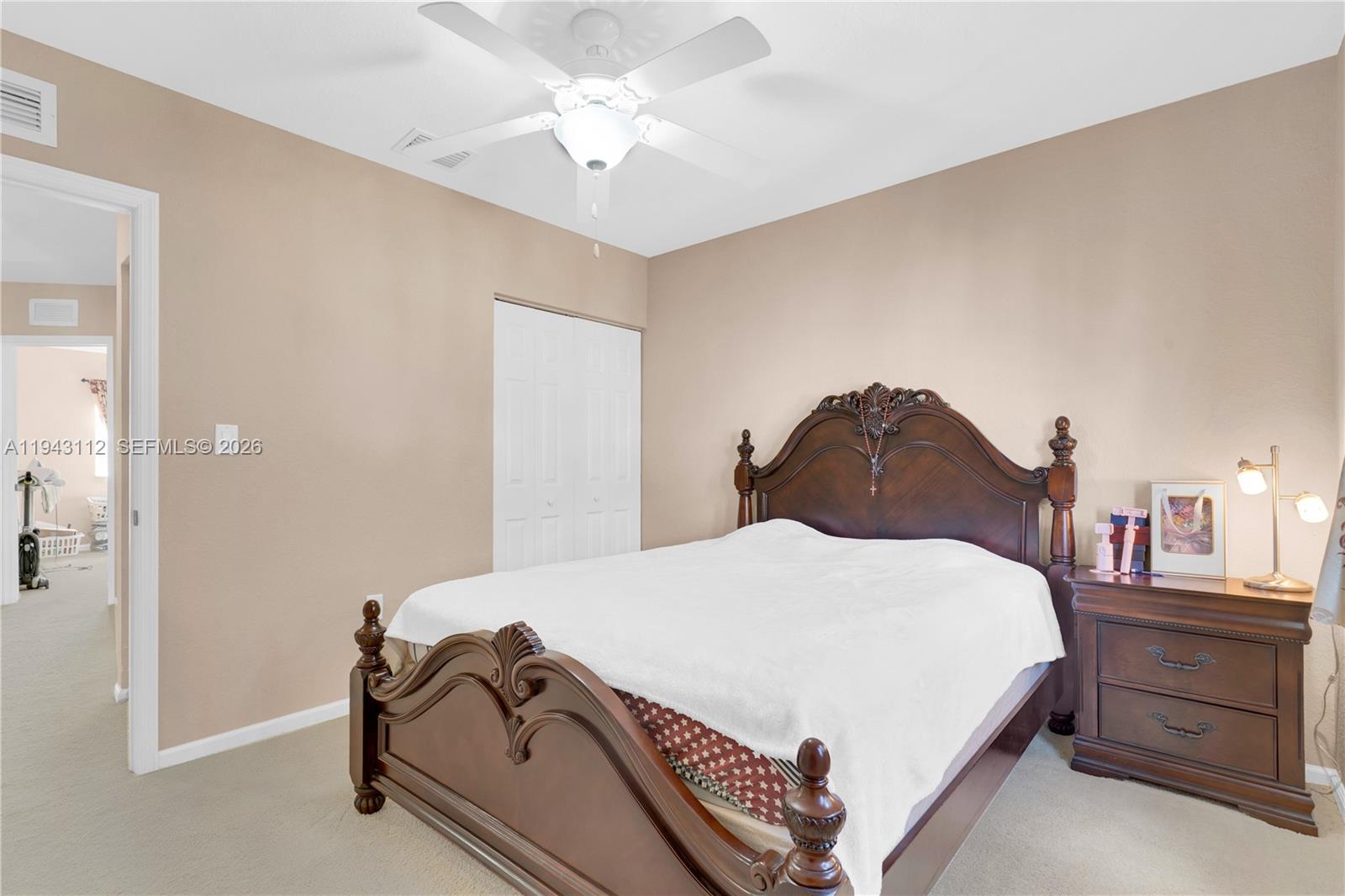 14102 Southwest 276th Street Homestead, FL 33032 - Photo 22 of 36 a bedroom with a bed and a chandelier