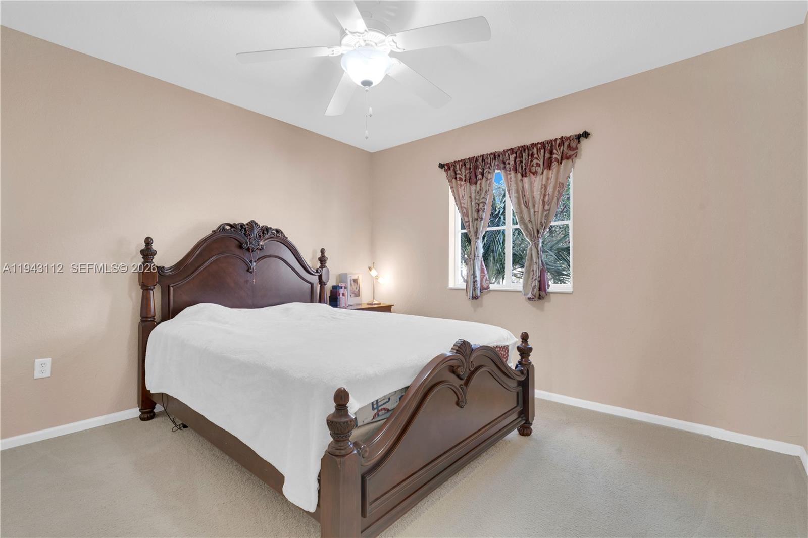 14102 Southwest 276th Street Homestead, FL 33032 - Photo 23 of 36 a bedroom with a bed and window