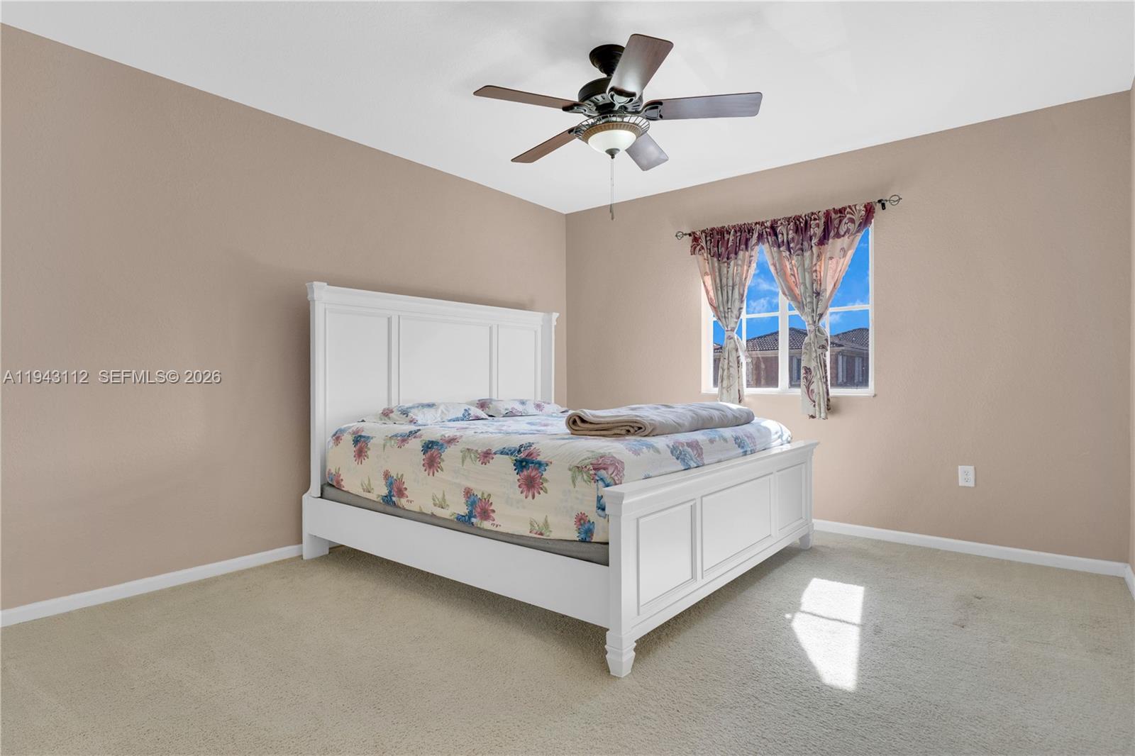 14102 Southwest 276th Street Homestead, FL 33032 - Photo 25 of 36 a white bed sitting in a bedroom next to a window