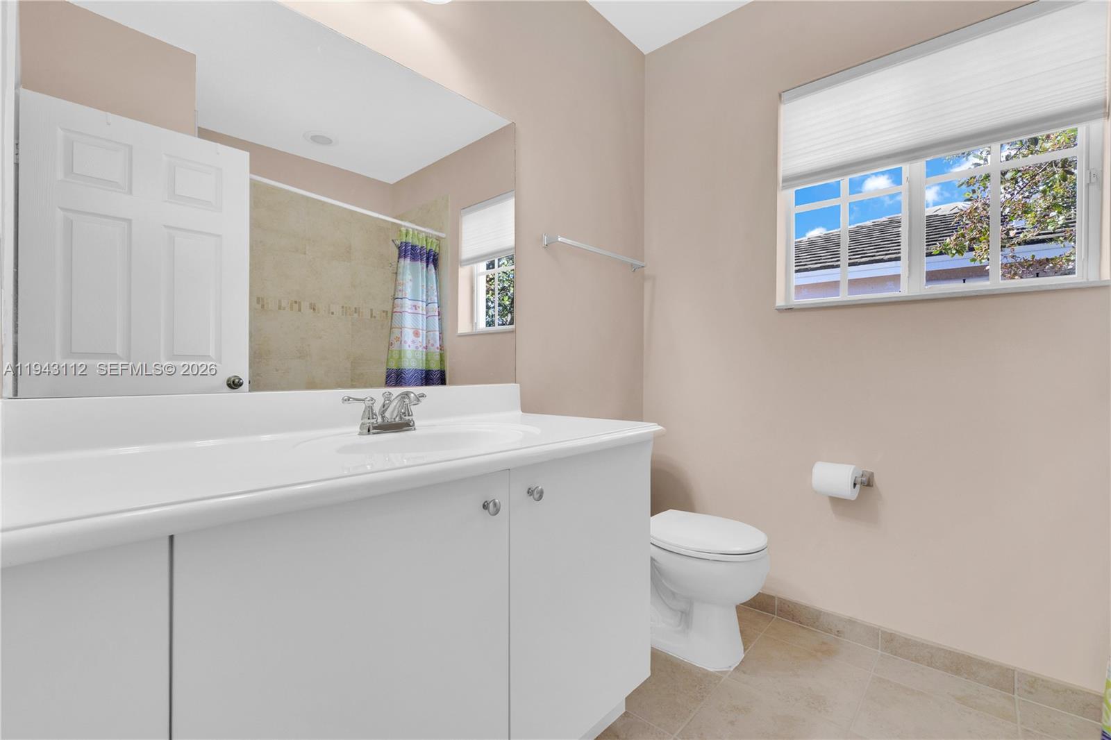 14102 Southwest 276th Street Homestead, FL 33032 - Photo 28 of 36 a bathroom with a sink a toilet and a mirror