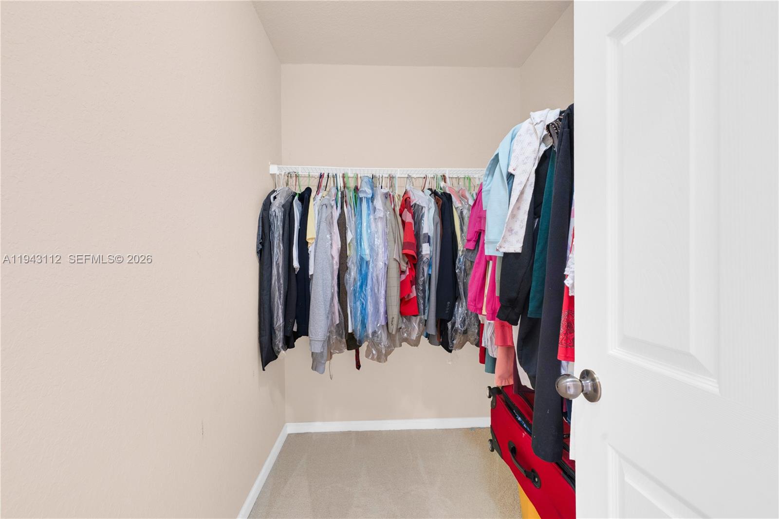 14102 Southwest 276th Street Homestead, FL 33032 - Photo 29 of 36 a view of walk in closet with clothes