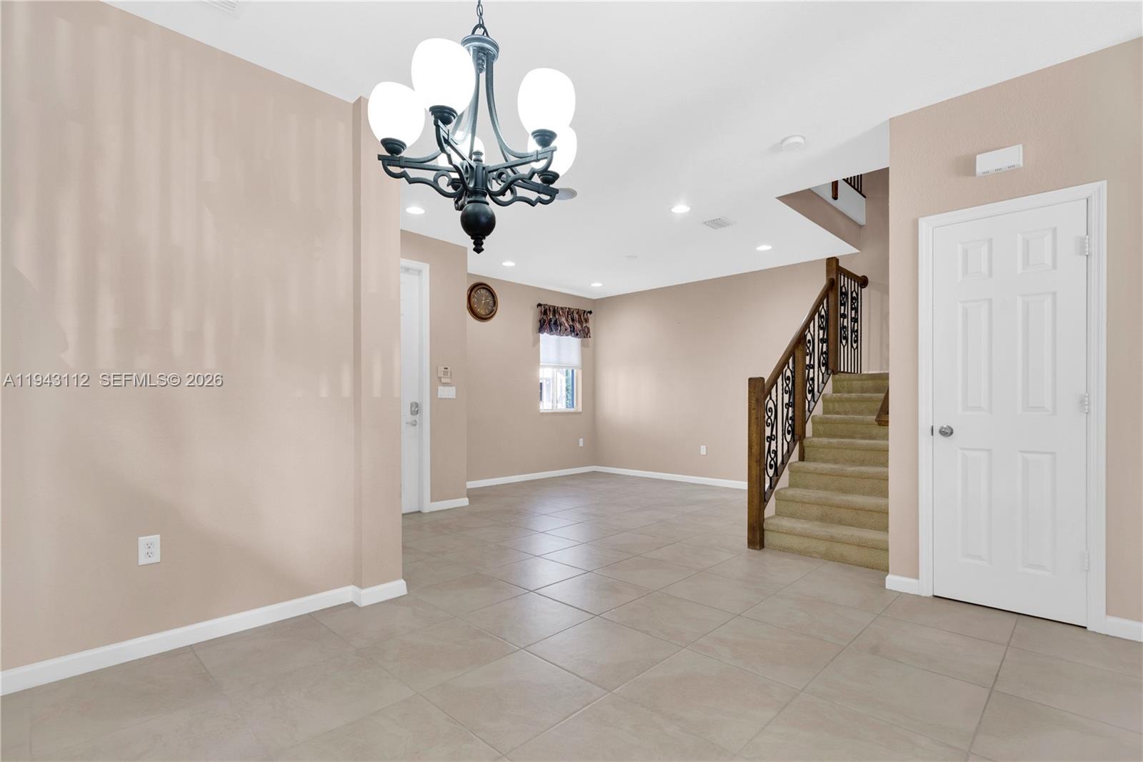 14102 Southwest 276th Street Homestead, FL 33032 - Photo 5 of 36 a view of a chandelier fan and entryway