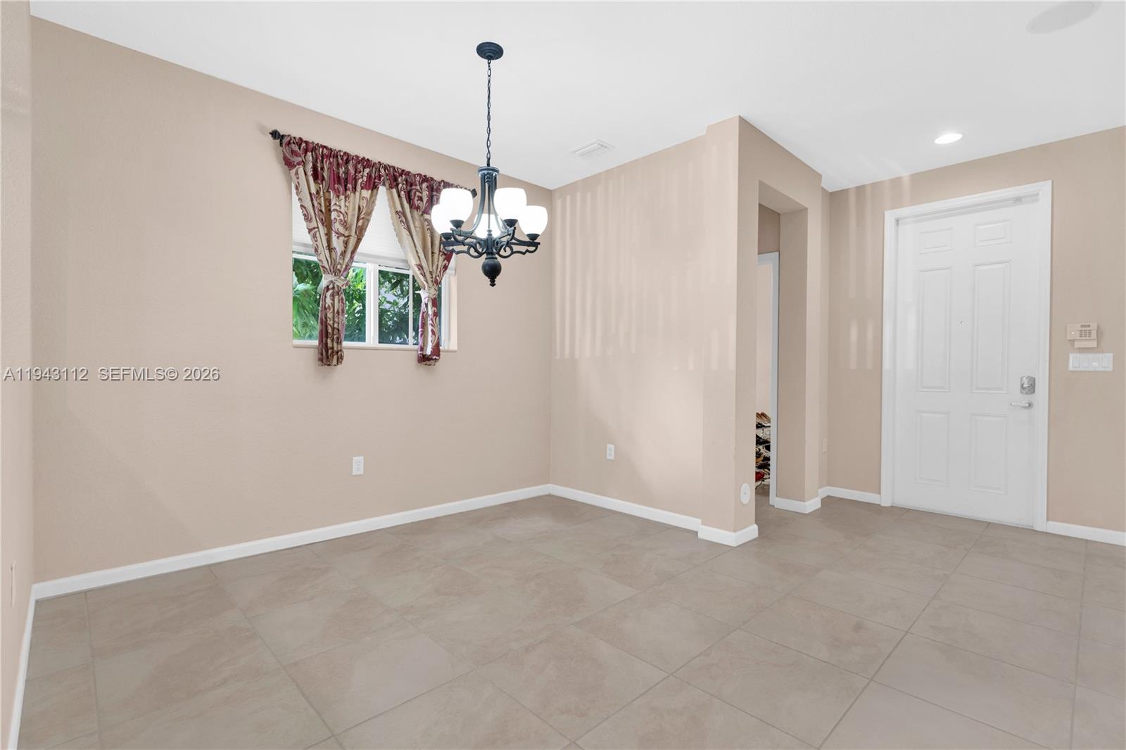 14102 Southwest 276th Street Homestead, FL 33032 - Photo 7 of 36 a view of a livingroom with a chandelier