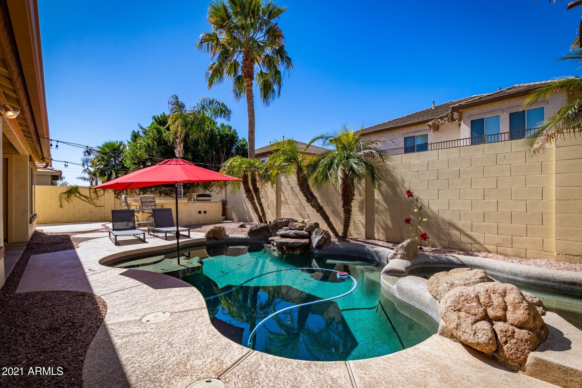 3124 South Martingale Road Gilbert, AZ 85295 - Photo 23 of 26 a view of a swimming pool with a patio