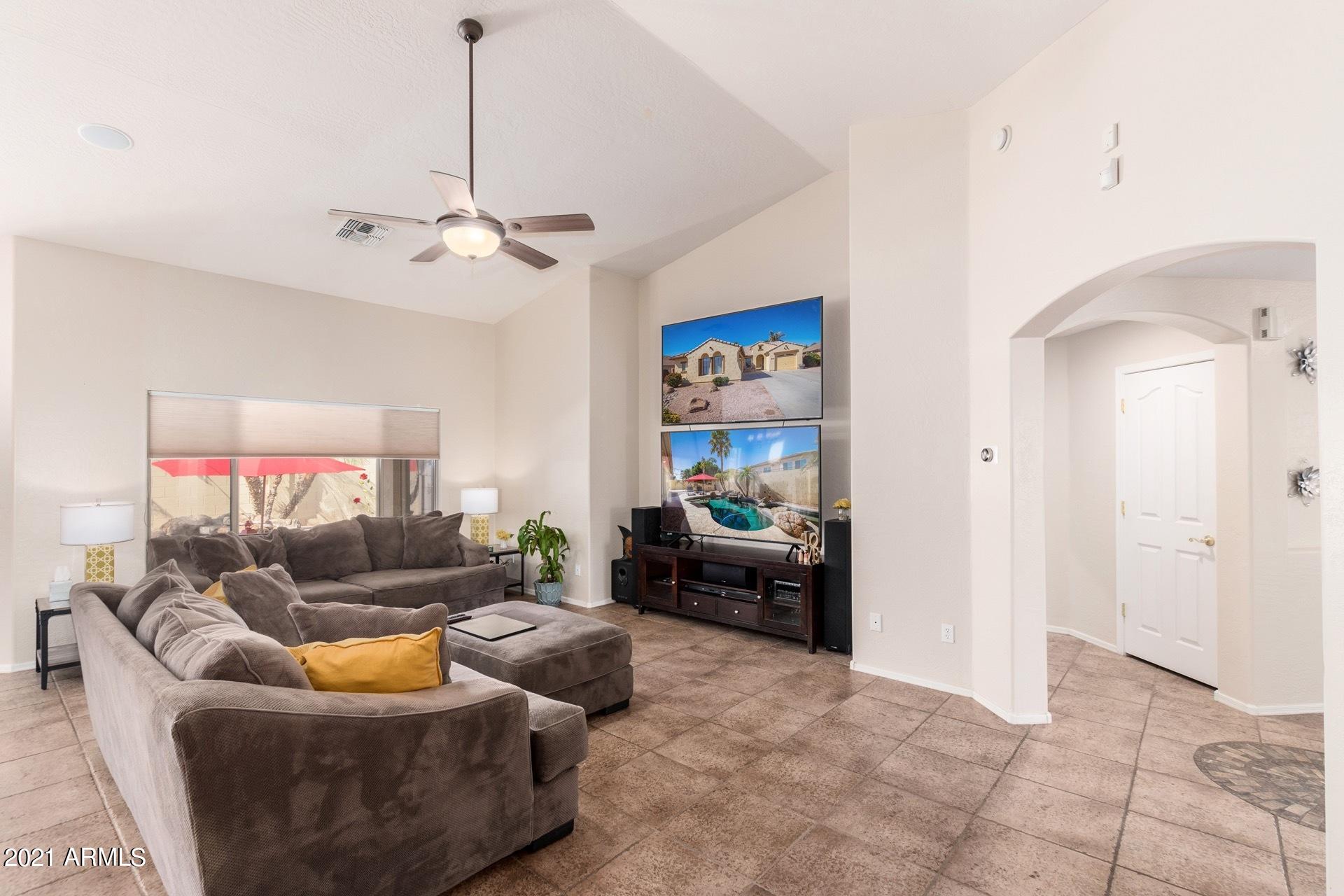 3124 South Martingale Road Gilbert, AZ 85295 - Photo 4 of 26 a living room with furniture and a chandelier