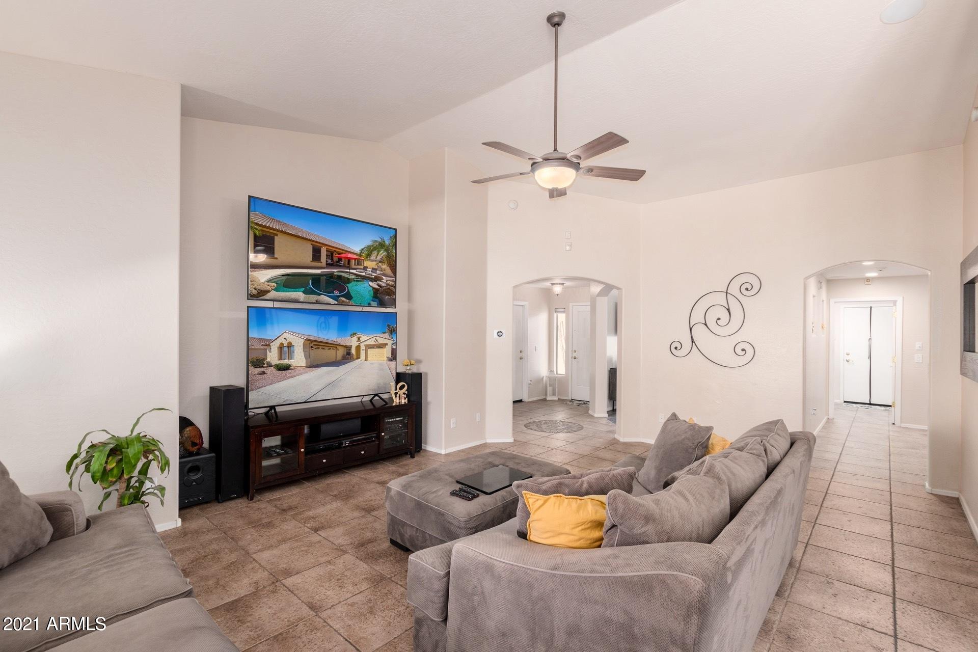 3124 South Martingale Road Gilbert, AZ 85295 - Photo 5 of 26 a living room with furniture and a chandelier