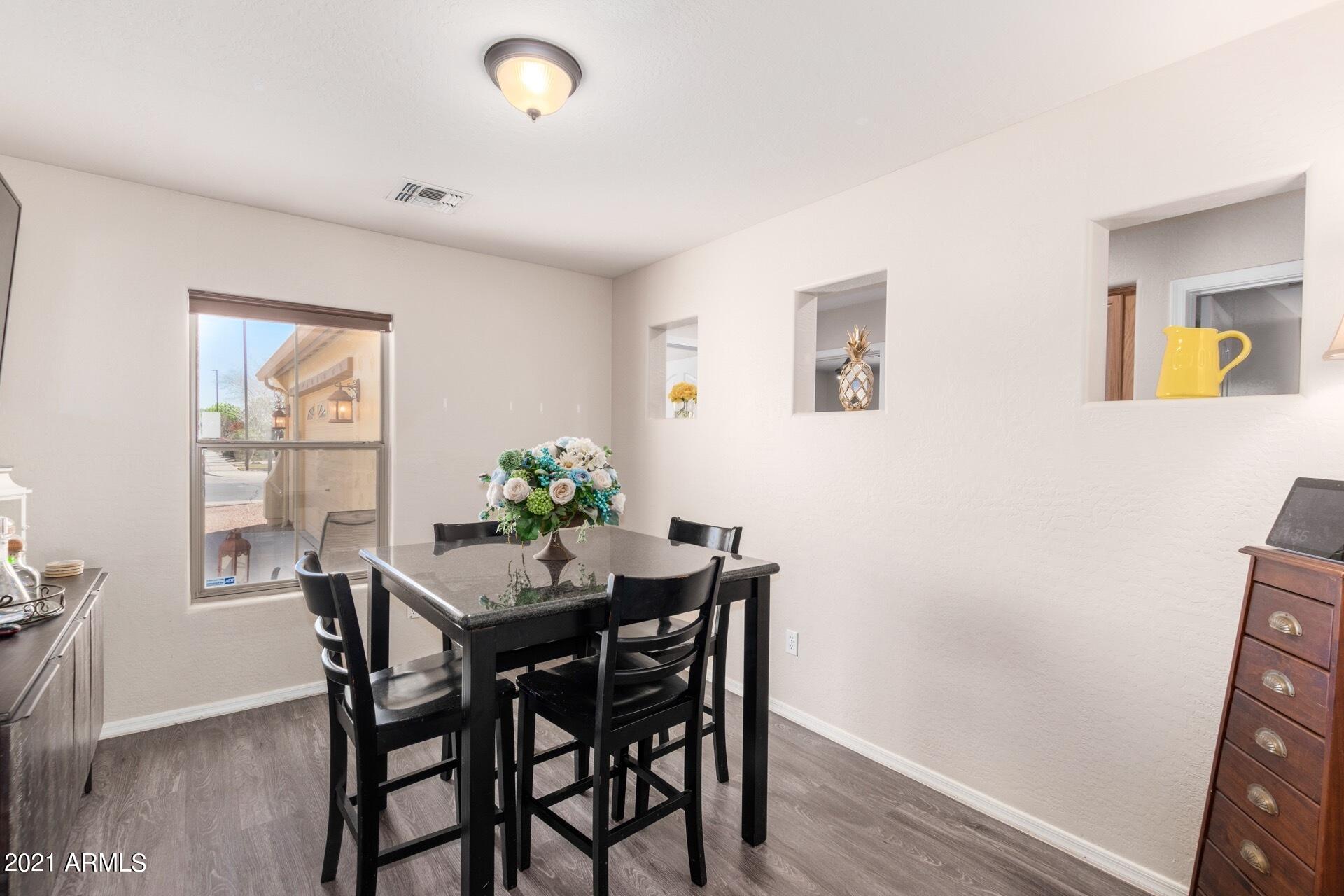 3124 South Martingale Road Gilbert, AZ 85295 - Photo 6 of 26 a view of a dining room with furniture and wooden floor