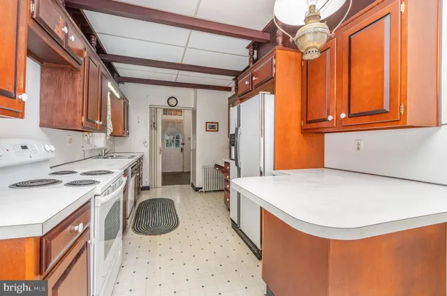 a kitchen that has a sink a stove and a window