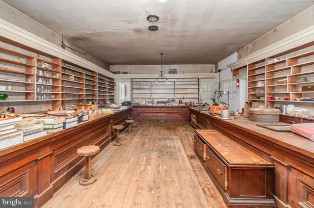 a view of a livingroom with wooden floor and a fireplace