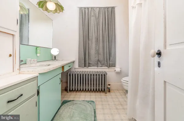 a bathroom with a sink toilet and a shower