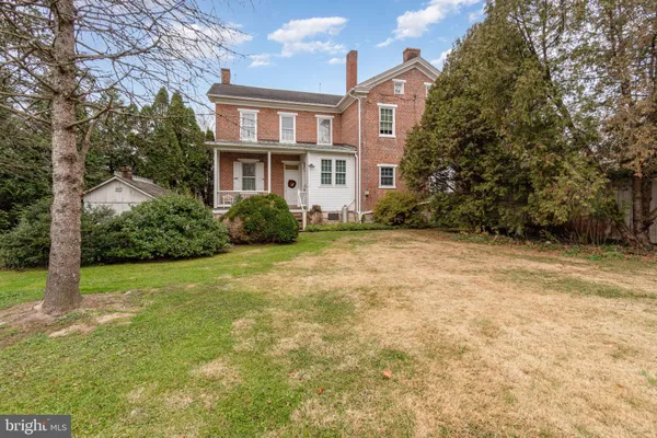 a view of a tree in front of a house
