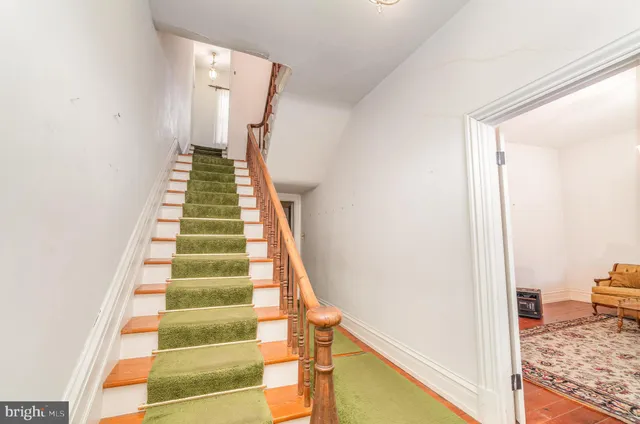 a view of a bedroom with wooden floor and stairs