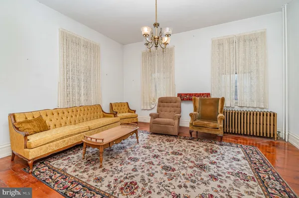 a living room with furniture and a chandelier
