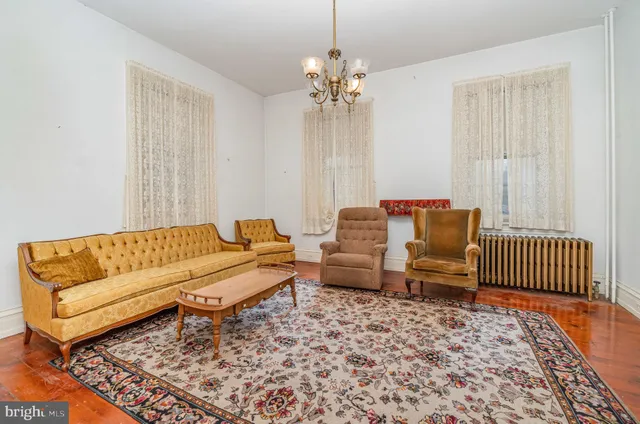 a living room with furniture and a chandelier