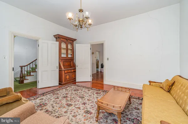 a living room with a couch and a chandelier