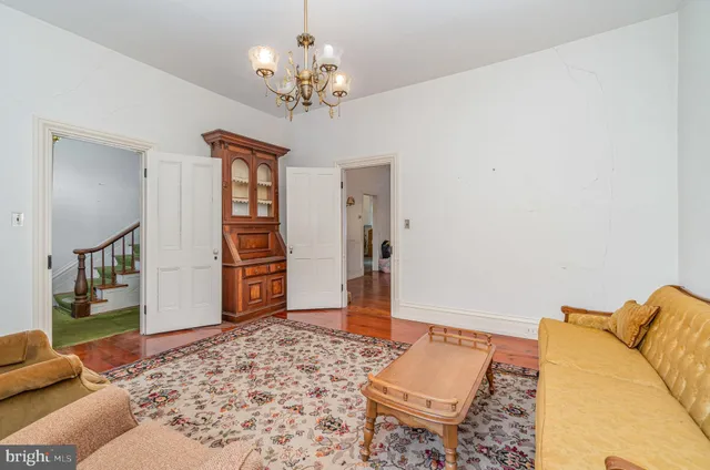 a living room with a couch and a chandelier