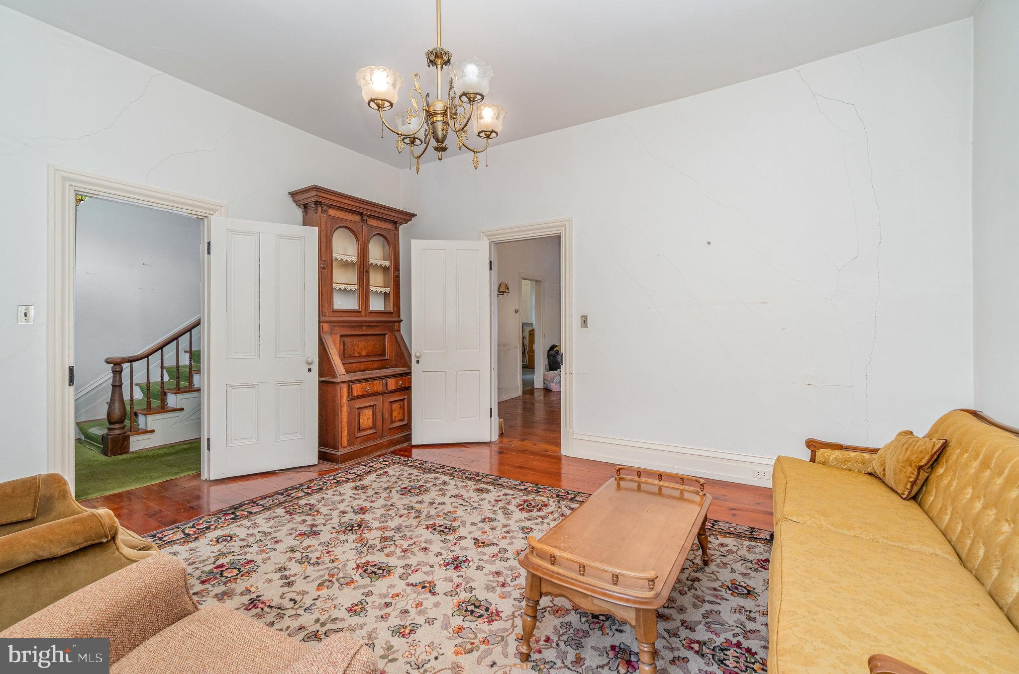 5575 Waggoners Gap Road Landisburg, PA 17040 - Photo 8 of 42 a living room with a couch and a chandelier