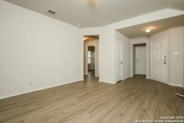 an empty room with wooden floor and closet