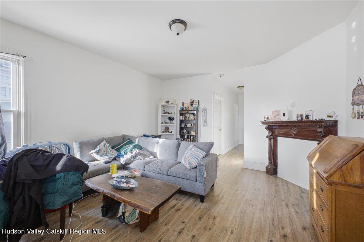 97 Maple Avenue Catskill, NY 12414 - Photo 20 of 27 a living room with furniture and a wooden floor