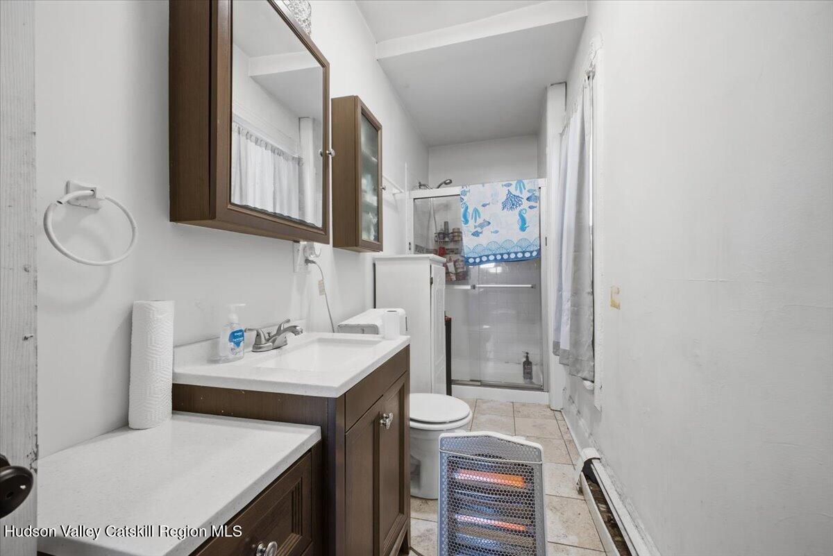 97 Maple Avenue Catskill, NY 12414 - Photo 21 of 27 a bathroom with a sink toilet and mirror