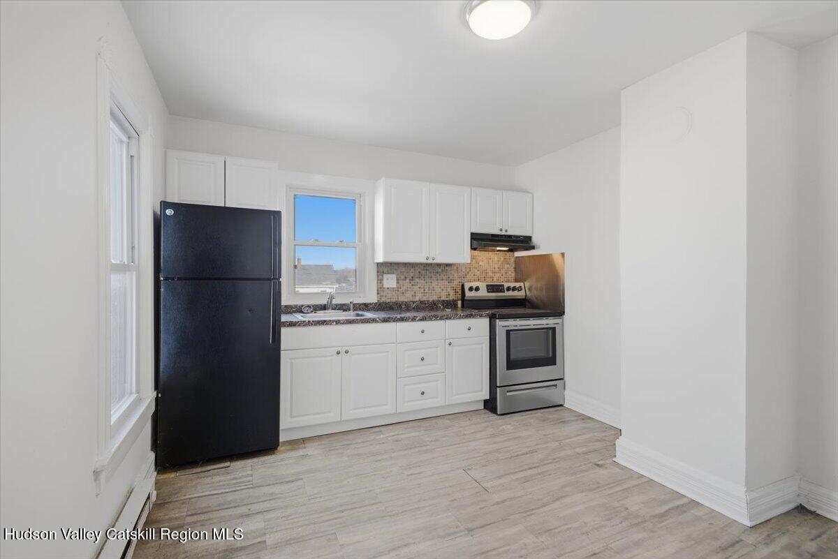 97 Maple Avenue Catskill, NY 12414 - Photo 6 of 27 a kitchen with a refrigerator and cabinets