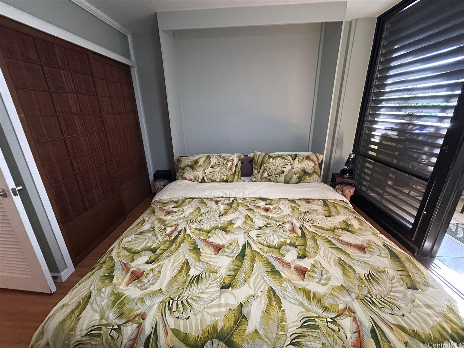 425 Ena Road, Unit 1208A Honolulu, HI 96815 - Photo 12 of 21 a bedroom with a bed and a window