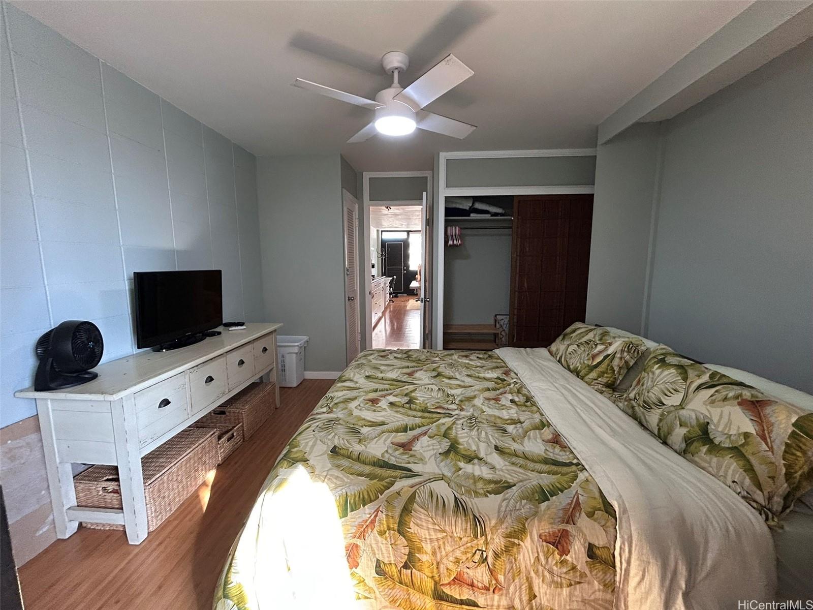 425 Ena Road, Unit 1208A Honolulu, HI 96815 - Photo 13 of 21 a bedroom with a bed and a flat screen tv