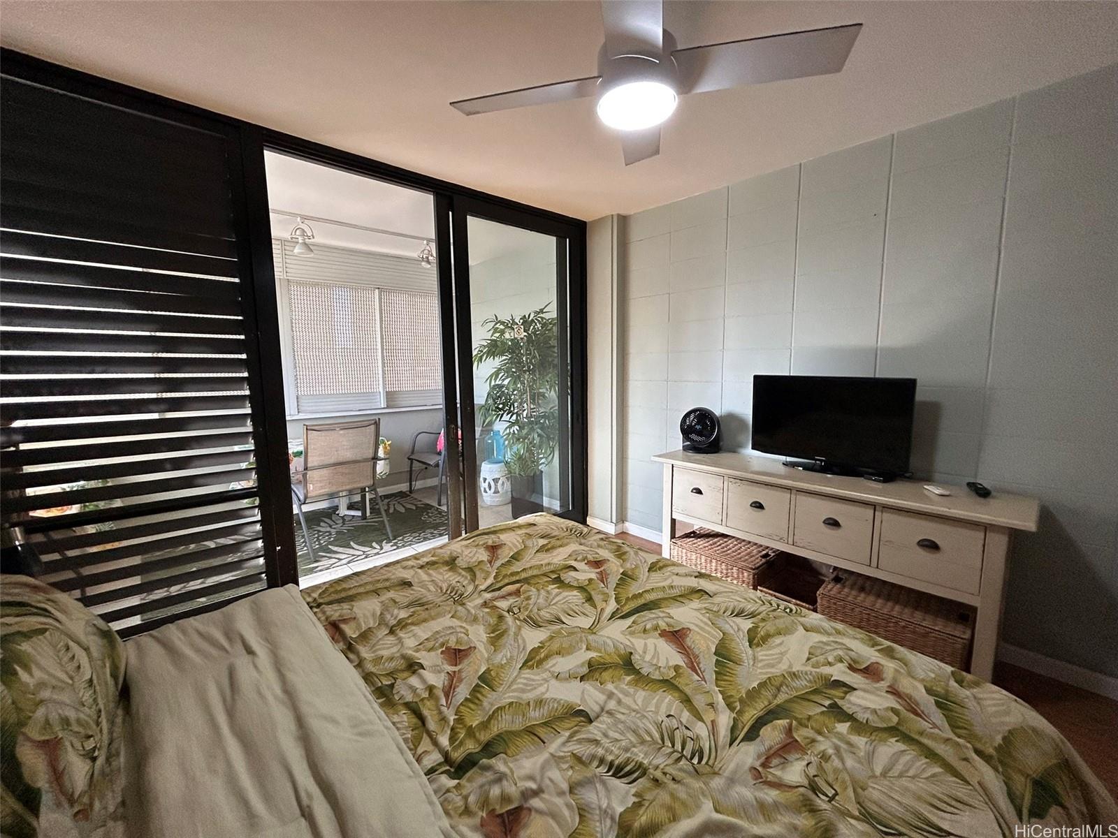 425 Ena Road, Unit 1208A Honolulu, HI 96815 - Photo 14 of 21 a bedroom with a bed and a television