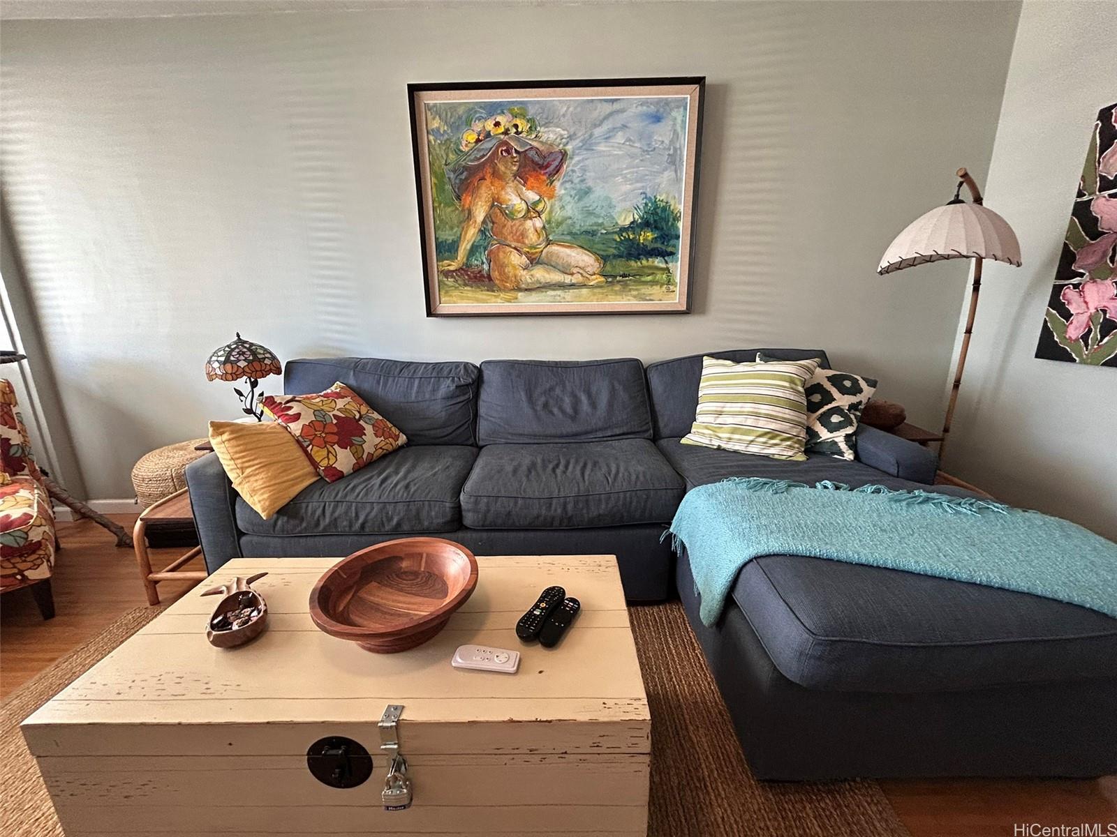 425 Ena Road, Unit 1208A Honolulu, HI 96815 - Photo 3 of 21 a living room with furniture and a couch