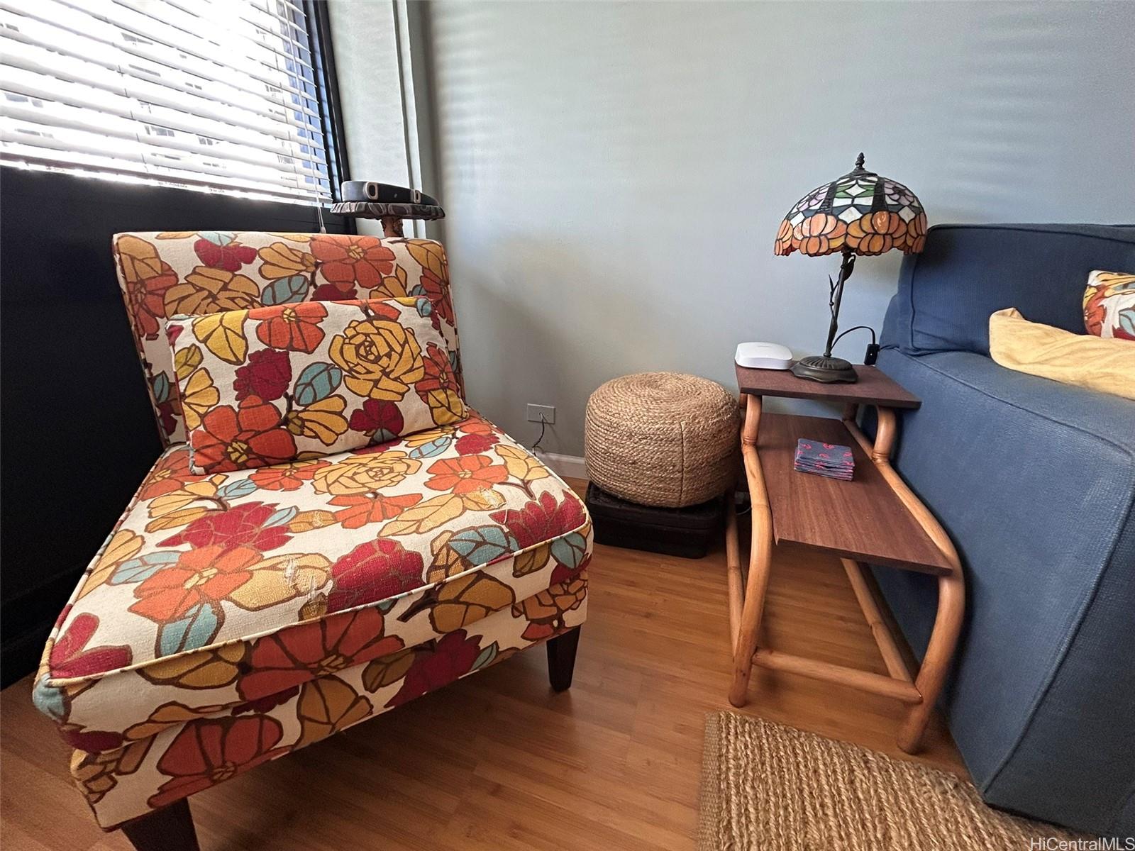 425 Ena Road, Unit 1208A Honolulu, HI 96815 - Photo 4 of 21 a bedroom with a bed and wooden floor