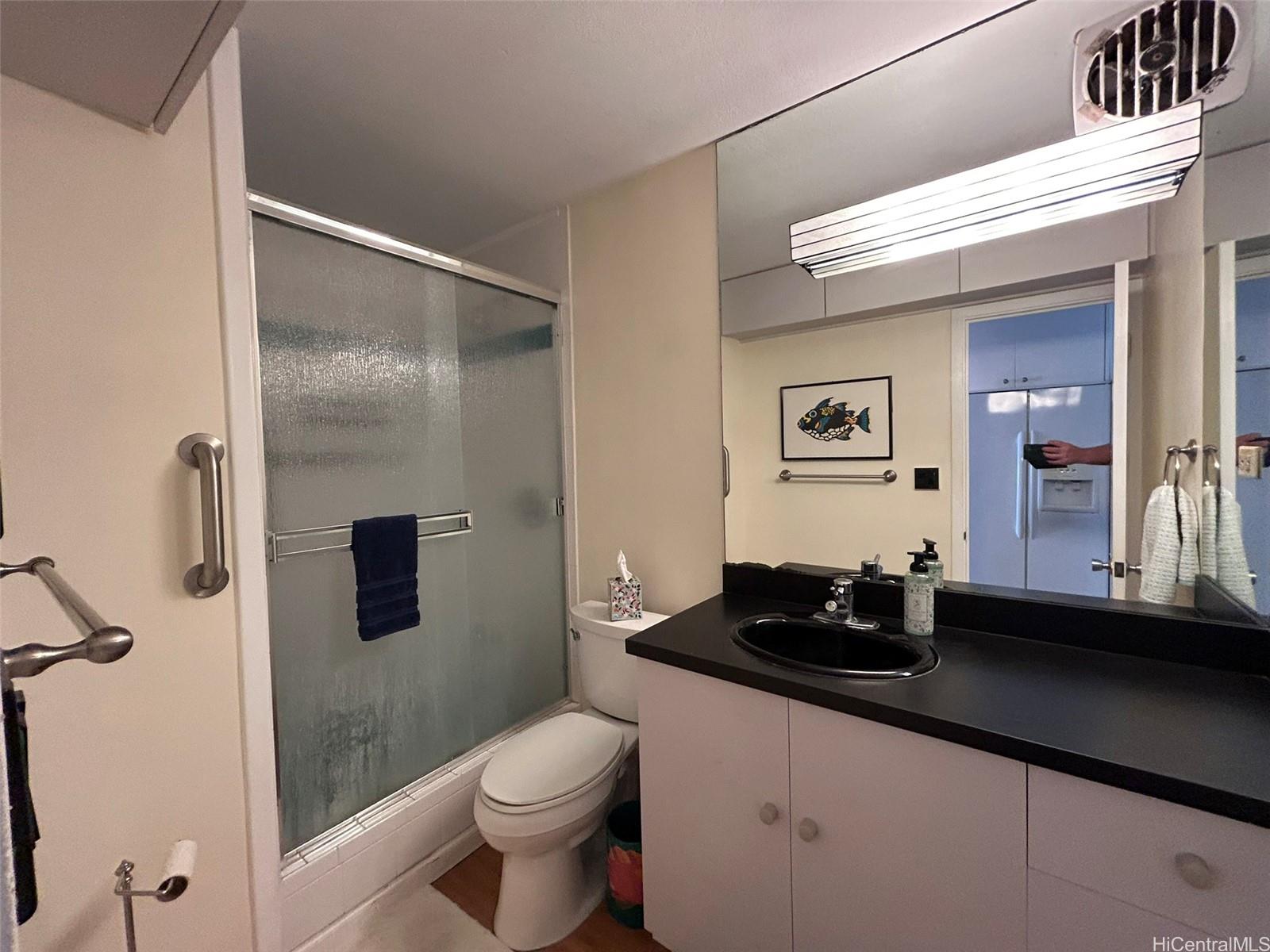 425 Ena Road, Unit 1208A Honolulu, HI 96815 - Photo 8 of 21 a bathroom with a sink a toilet and shower