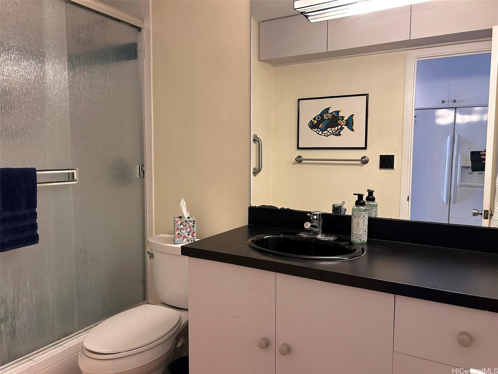 425 Ena Road, Unit 1208A Honolulu, HI 96815 - Photo 9 of 21 a bathroom with a granite countertop sink mirror and toilet