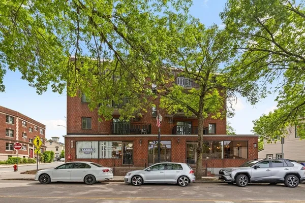 a view of cars parked in front of a house