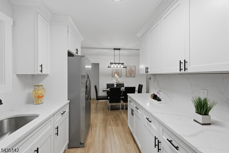 36 Ruth Street Hopatcong, NJ 07874 - Photo 7 of 25 a kitchen with white cabinets and white appliances