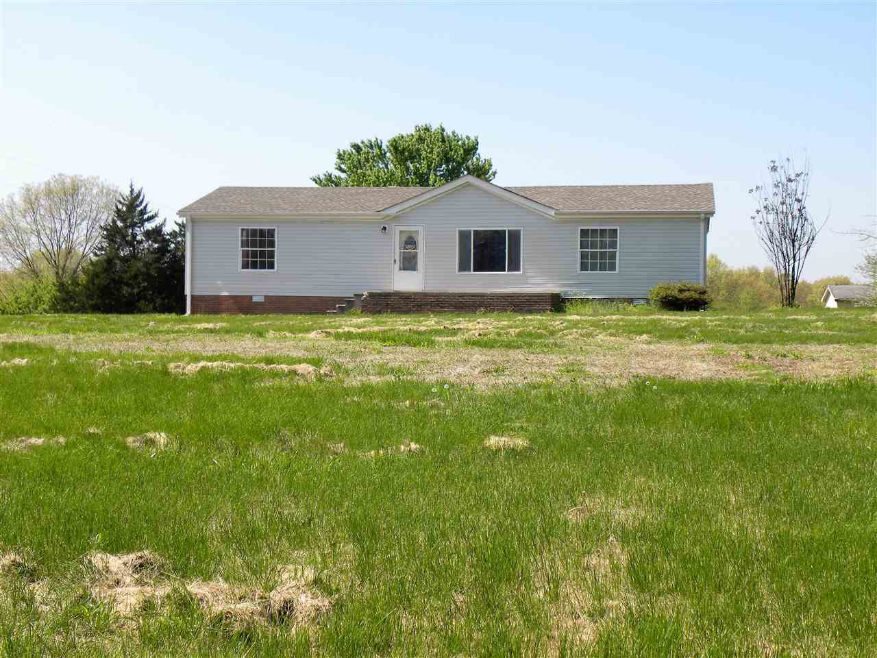 64 Eldad Road Trenton, TN 38382 - Photo 1 of 1 a view of a yard in front of a house with a large tree