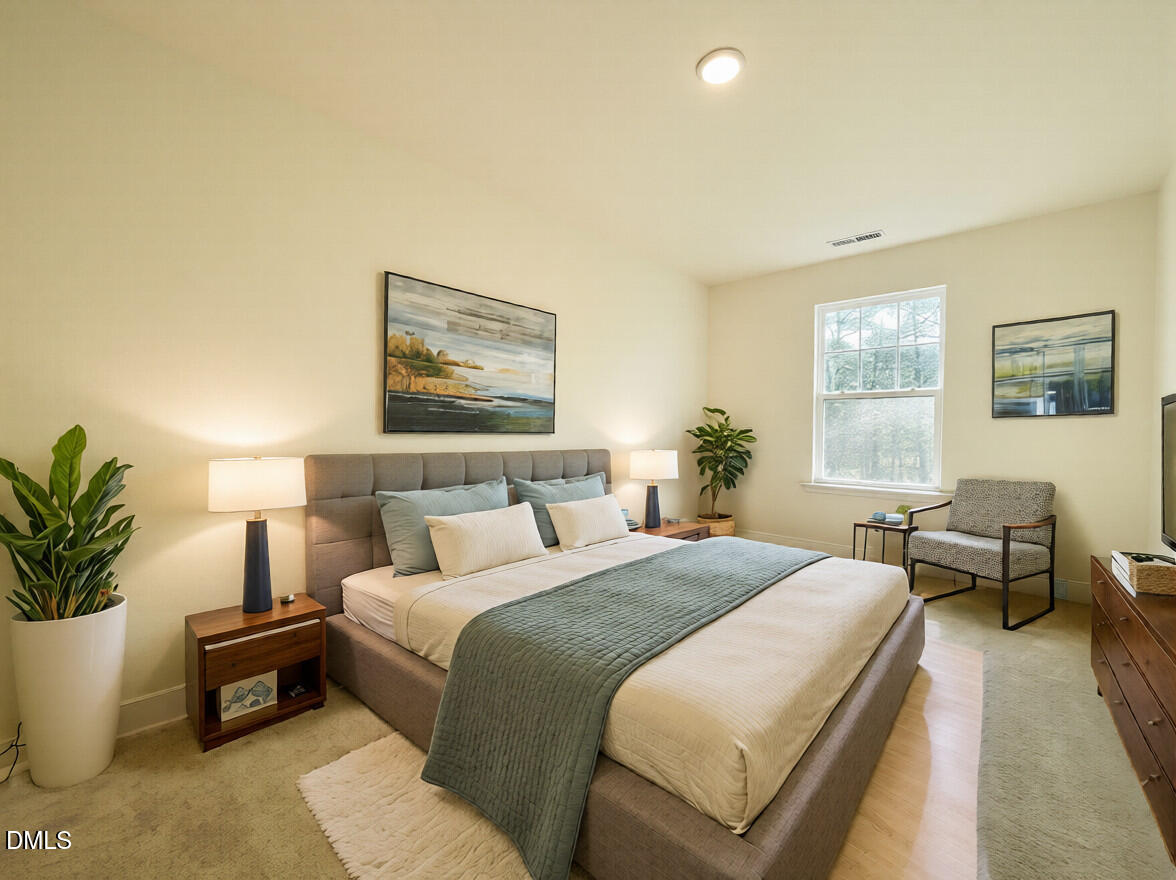 6429 Granite Quarry Drive Raleigh, NC 27610 - Photo 12 of 21 a bedroom with a large bed and potted plant